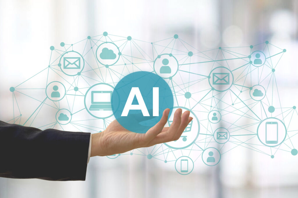 手のひらに浮かぶ「AI」の文字と、周りにつながるメールや人物のアイコン
